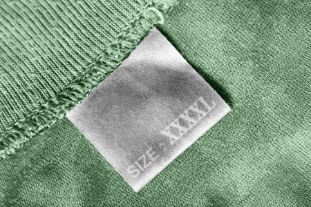 XXXXL size clothes label on green textile background closeupの写真素材