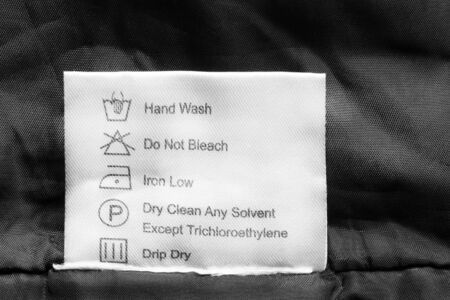 Washing instructions clothes label on black cloth closeupの写真素材