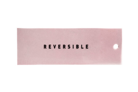 Pink label lettered reversible isolated over white