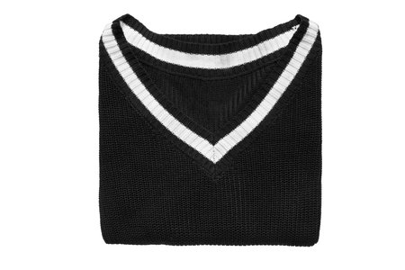 Black and white folded casual sweater on white backgroundの写真素材