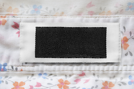 Black and white blank clothes label on cotton background closeupの写真素材