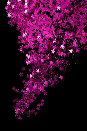 Abstract pink metallic stars glitter on black background