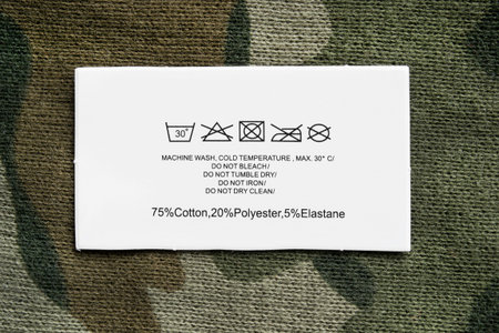 Content and care clothes label on knitted khaki backgroundの写真素材