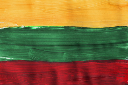 Painted Lithuanian national tricolor closeup as a backgroundの写真素材