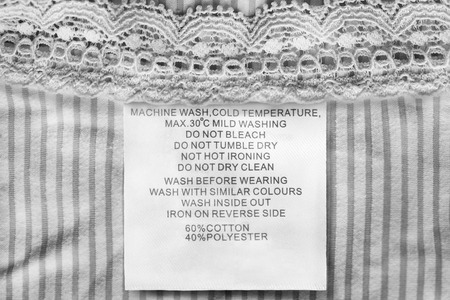 Composition and care clothes label on white textile background closeupの写真素材