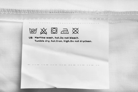Care clothes label on white textile background closeup