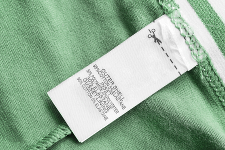 Composotion clothes label on green textile backgroundの写真素材
