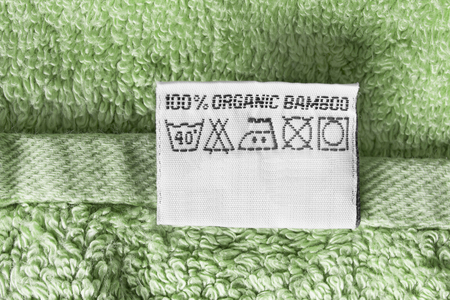 Composition and care clothes label on green terry towel closeupの写真素材