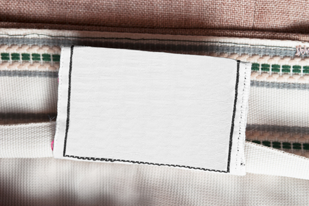 Blank textile clothes label on textile background closeupの写真素材