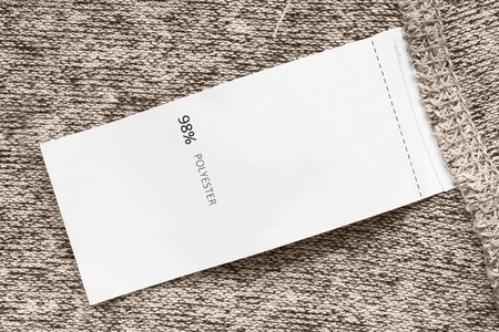 Composition clothes label on beige knitted background closeupの写真素材