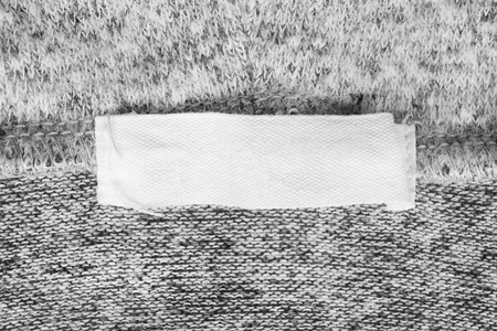 White blank textile clothes label on knitted wool backgroundの写真素材