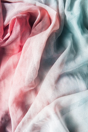 Crumpled blue and pink chiffon closeup as a backgroundの写真素材