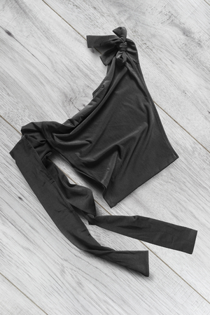 Crumpled black silk crop top on white wooden backgroundの写真素材