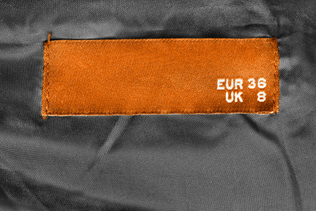 36 size clothes label on black textile background closeup