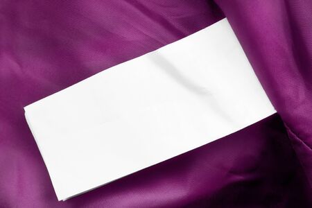 Blank white clothes label on magenta pink textile backgroundの写真素材