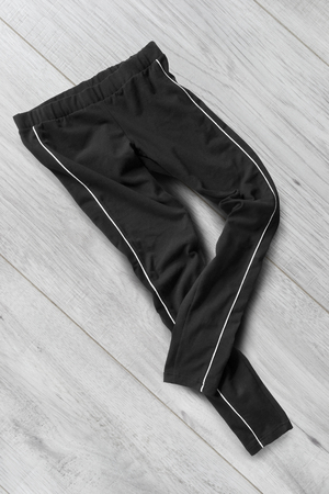 Crumpled black pants on white wooden backgroundの写真素材