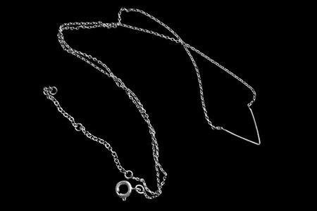 Elegant silver chain necklace on black backgroundの写真素材