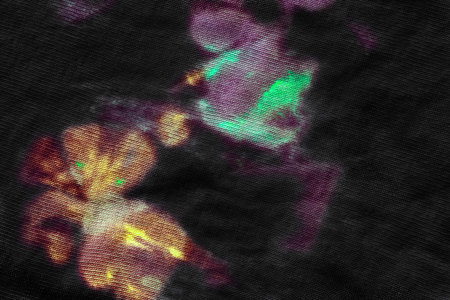 Black textile canvas with stains of neon colorful paint as a background
