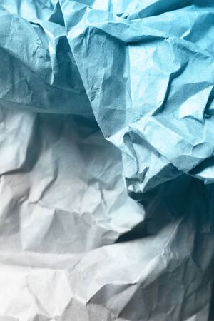 Blue and white crumpled blank paper as a backgroundの写真素材