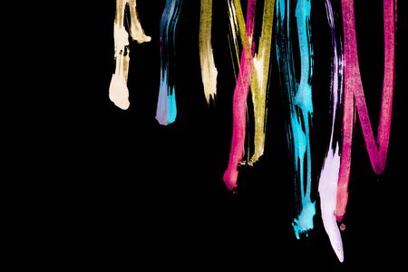 Colorful abstract paint streaks on black as a backgroundの写真素材