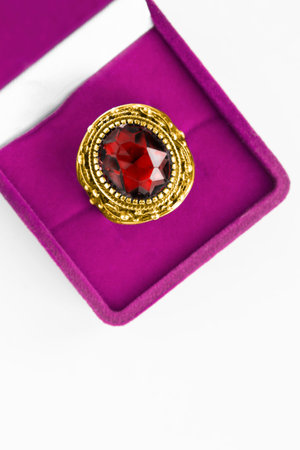 Large rube gold ring in pink jewel box closeup