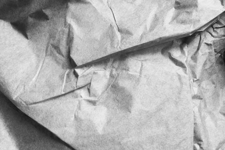 Blank grey crumpled craft paper texture closeup