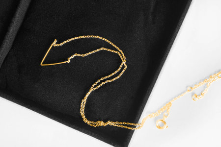 Elegant gold chain necklace in black jewel box closeup