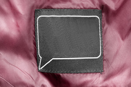 Blank textile clothes label on pink textile background closeupの写真素材