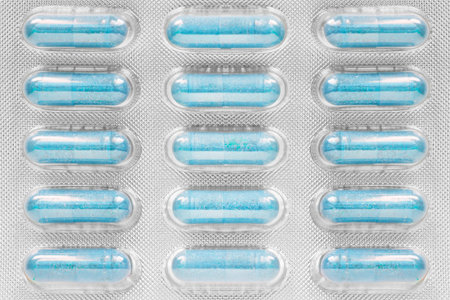 Blue pills in a blister closeup as a background