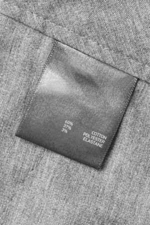 Fabric composition clothes label on grey textile backgroundの写真素材