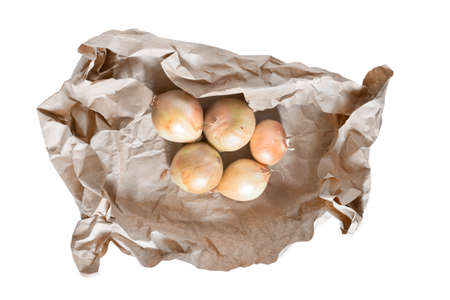 Five raw onions wrapped in craft paper isolated over whiteの写真素材