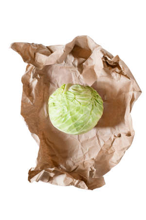 Head of cabbage wrapped in craft paper isolated over whiteの写真素材