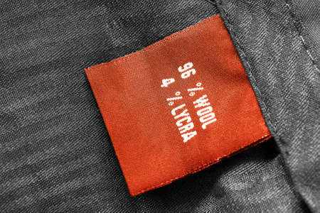 Fabric composition clothes label on black textile backgroundの写真素材