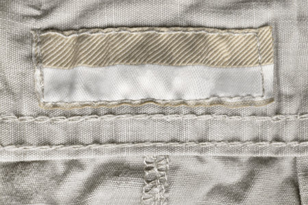 Blank clothing label on textile cotton background