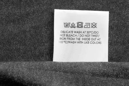 Care clothing label on gray textile background closeupの写真素材
