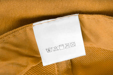 Care clothing label on yellow textile backgroundの写真素材