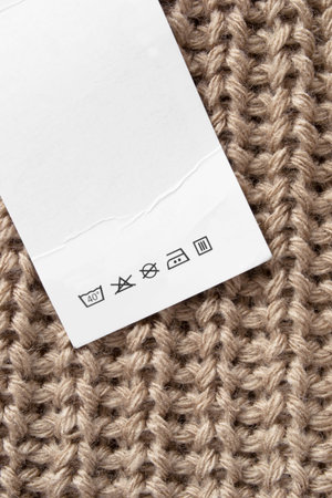 Care instructions clothing label on brown knit background closeupの写真素材