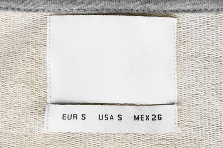 Size S clothing label on textile knit background closeup