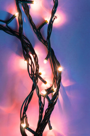 Pink led lights decorative garland on blue background closeupの写真素材