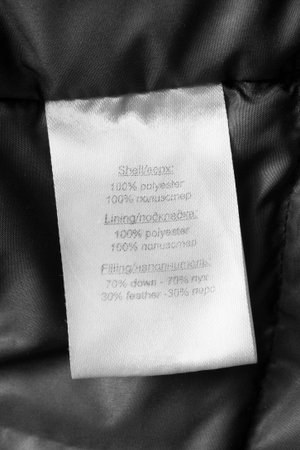 Fabric composition clothing label in english and russian languages closeup