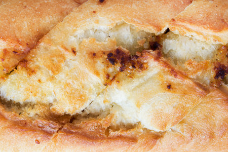 Wheat sourdough loaf crust closeup as a background
