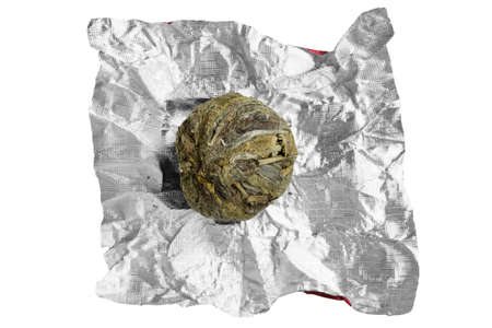 Foil wrapped green tea ball isolated on white backgroundの写真素材