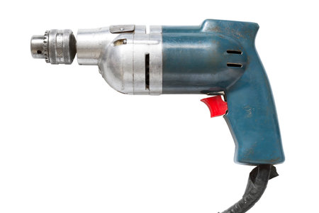 Old wired electrical drill isolated over white