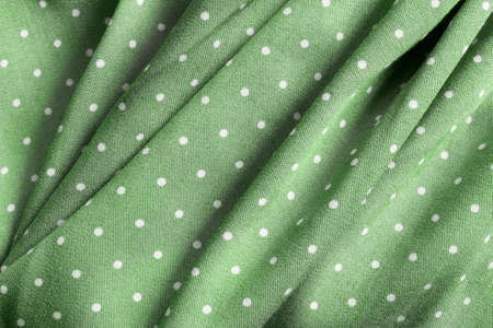 Polka dots green textile draped backgoundの写真素材
