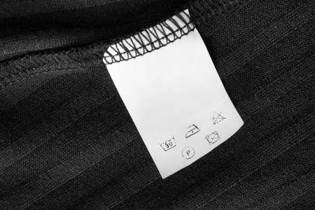 Care instructions clothing label on black knit backgroundの写真素材