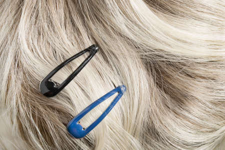 Two simple clip barrettes on ash blonde hair closeupの写真素材