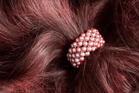 Pink pearl scrunchy on red brown hair closeupの写真素材