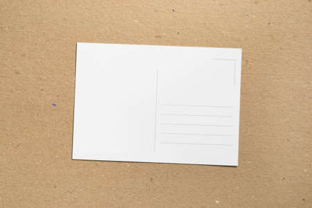 Empty postcard blank on brown cardboard backgroundの写真素材