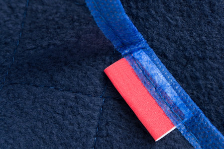 Empty clothing label on blue textile background