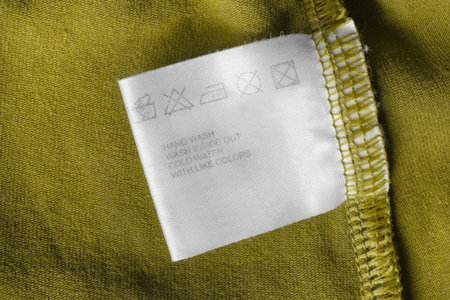 Care instructions clothing label on green textile backgroundの写真素材